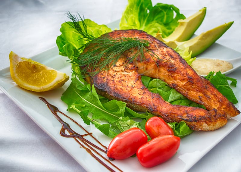 Grilled salmon plate with vegetables and lemon